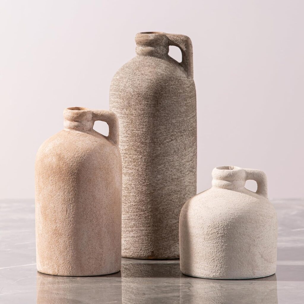 A white ceramic vase with a unique ribbed texture, empty and styled as a minimalist centerpiece on a wooden table.