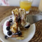 Oat banana pancakes topped with fresh berries and yogurt